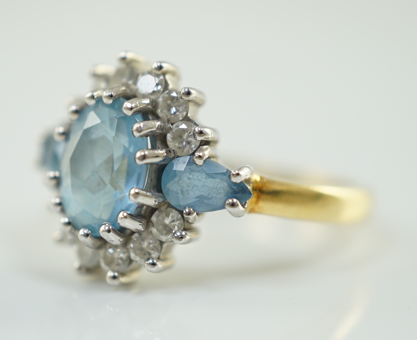 A 1970's 18ct gold, aquamarine and diamond set oval cluster ring, by Cropp & Farr